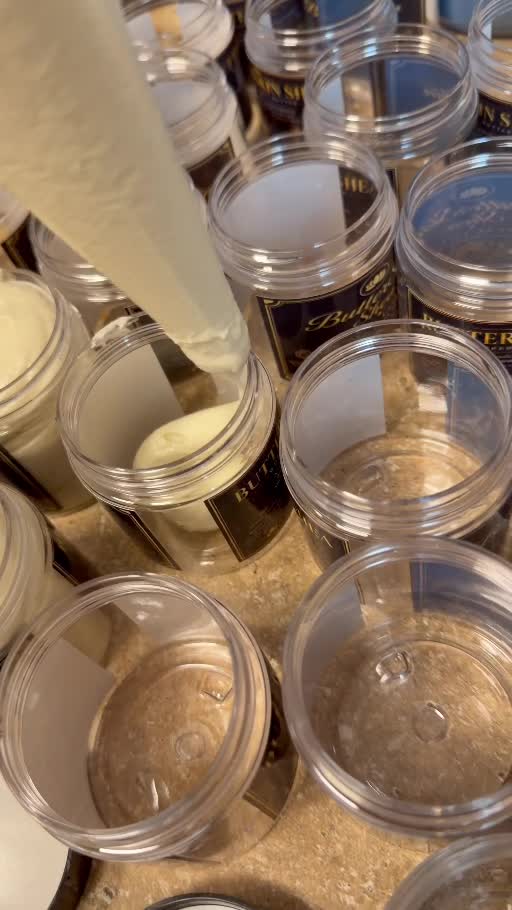 Royal Lotus whipped body butter being piped into ButterSkin Shea jars during production